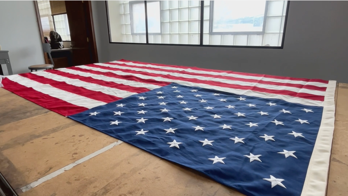 American flag laid out flat on a work table inside Allied Materials factory